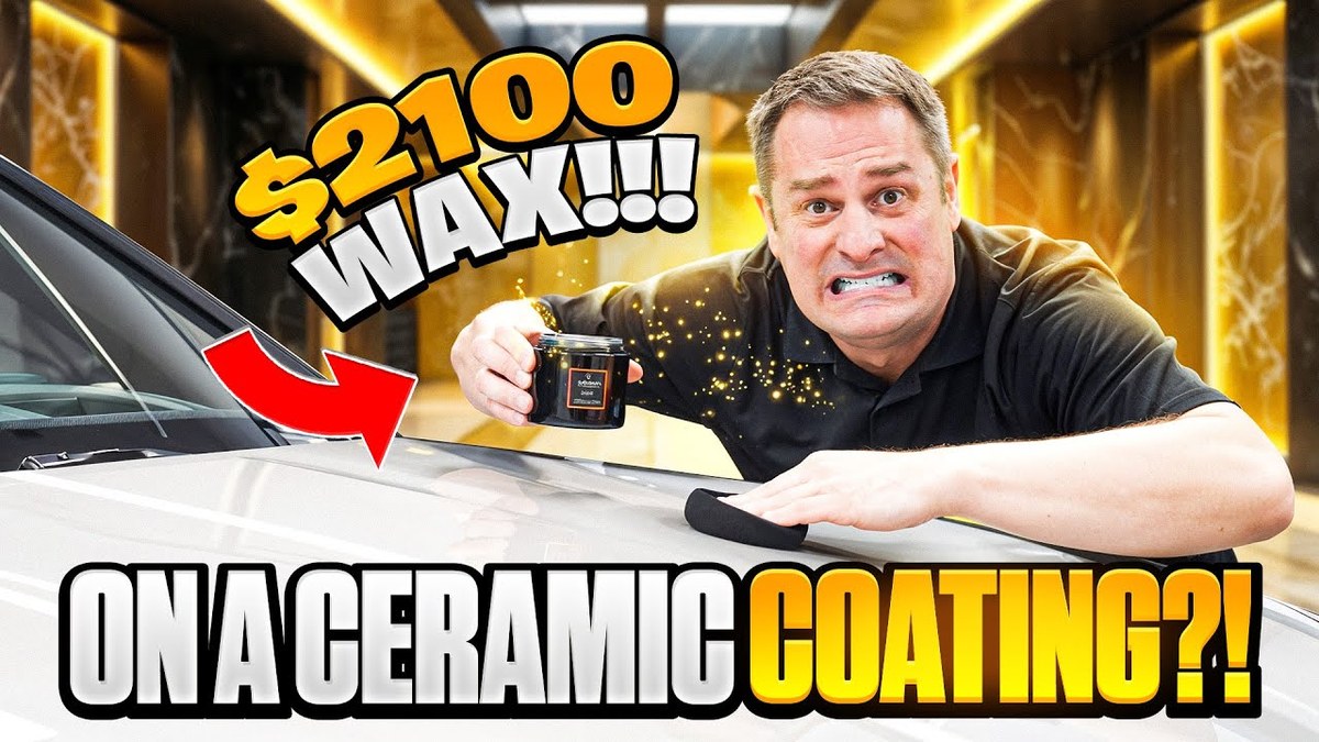 Hand applying wax onto a car hood with a foam applicator pad over ceramic coating.