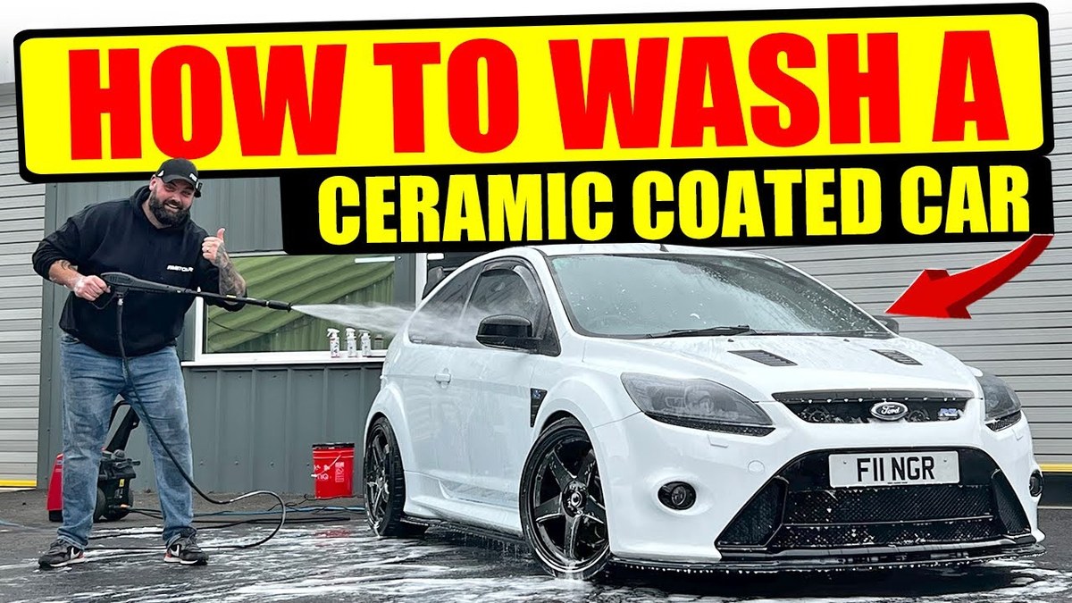 Person hand-washing a ceramic-coated sedan with a microfiber mitt and pH-neutral shampoo