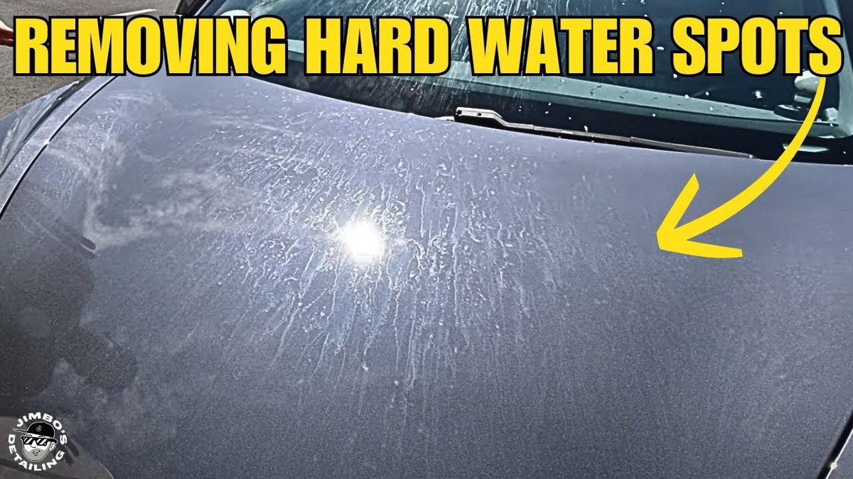 Close-up of a car hood showing water spots on ceramic coating surface