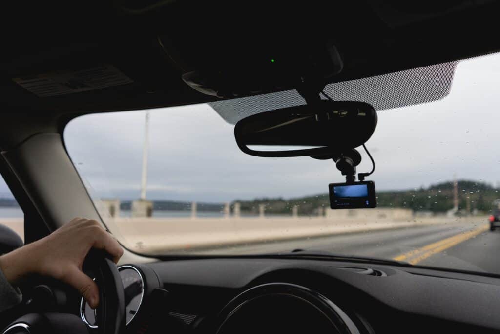 Diagram of car windshield showing legal 5-inch dash cam placement below rearview mirror